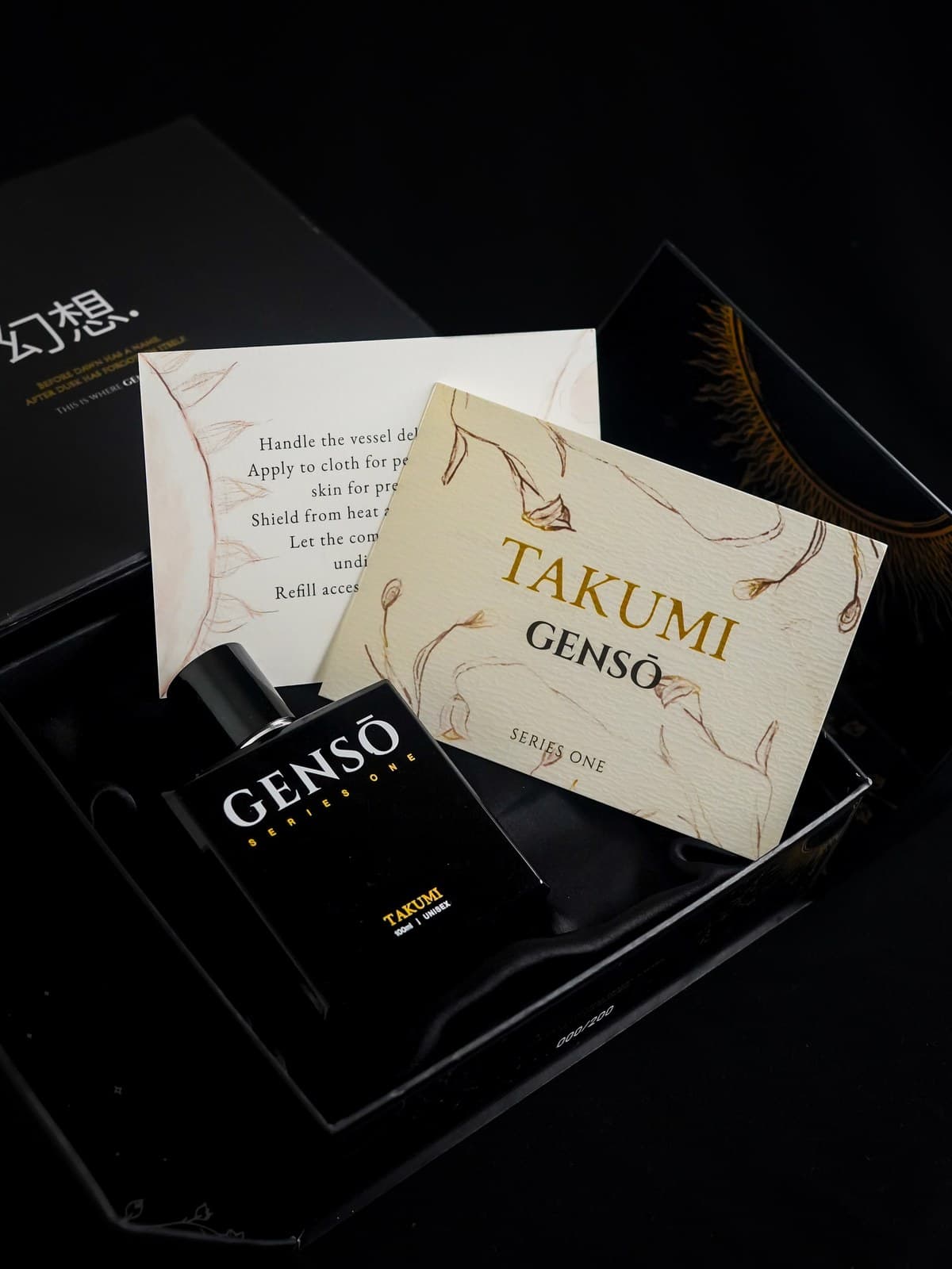 TAKUMI GENSŌ — the open box with the bottle seated inside, the printed care note and the cream Series One card